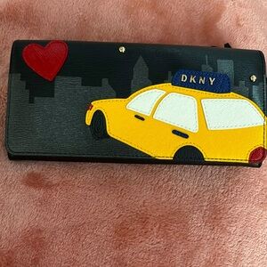 Beautiful DKNY NWT Bobi Taxi carryall wallet black with taxi cab & heart design.